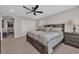 Cozy bedroom with a ceiling fan, carpet, and a comfortable king-sized bed at 6121 Bolsena Place, Myrtle Beach, SC 29572