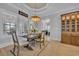 Cozy dining area with a wooden table, chairs, custom buffet, and natural light streaming through plantation shutters at 6121 Bolsena Place, Myrtle Beach, SC 29572
