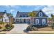 Daytime view of a charming home with a manicured lawn and concrete driveway at 6121 Bolsena Place, Myrtle Beach, SC 29572