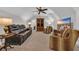 This living room features a large leather sofa, animal print chairs, and a large television at 6121 Bolsena Place, Myrtle Beach, SC 29572
