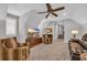 Spacious living room features high ceilings, a ceiling fan, and plush carpeting at 6121 Bolsena Place, Myrtle Beach, SC 29572