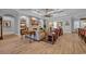 Open-concept living room with fireplace, hardwood floors, and coffered ceilings at 6121 Bolsena Place, Myrtle Beach, SC 29572