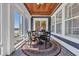 Charming sunroom featuring a round table, comfortable chairs, area rug, and views of the surrounding landscape at 6121 Bolsena Place, Myrtle Beach, SC 29572