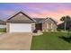 Charming single-story home with a two-car garage, brick accents, and lush green lawn at 621 Swinford Dr., Myrtle Beach, SC 29588