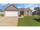 Charming single-story home with a two-car garage, brick accents, and lush green lawn at 621 Swinford Dr., Myrtle Beach, SC 29588