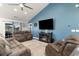 Cozy living room with blue accent wall, comfortable seating, and a modern entertainment center at 621 Swinford Dr., Myrtle Beach, SC 29588