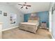 Main bedroom with a ceiling fan, accent wall and large window offering natural light at 621 Swinford Dr., Myrtle Beach, SC 29588