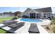 Resort-style backyard featuring a pool, lounge chairs, a tiki bar and a screened porch at 621 Swinford Dr., Myrtle Beach, SC 29588