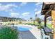 Landscaped backyard featuring a pool with a tiki bar, lounge chairs and beautiful surroundings at 621 Swinford Dr., Myrtle Beach, SC 29588