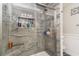 Luxurious shower with stone-look tile and built-in shelving for toiletries at 621 Swinford Dr., Myrtle Beach, SC 29588