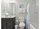 This bathroom features a dark wood vanity with a white sink, a toilet, and a shower and tub at 6253 Catalina Dr. # 713, North Myrtle Beach, SC 29582