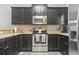 Kitchen with stainless steel appliances, dark cabinets, stylish backsplash and updated countertops at 6253 Catalina Dr. # 713, North Myrtle Beach, SC 29582