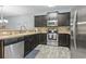 Modern kitchen with dark cabinets, stainless steel appliances, and tile backsplash at 6253 Catalina Dr. # 713, North Myrtle Beach, SC 29582