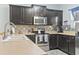 Kitchen boasting stainless steel appliances, dark cabinetry, stylish backsplash, and wood-look flooring at 6253 Catalina Dr. # 713, North Myrtle Beach, SC 29582