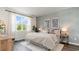 Serene bedroom with a large window, textured wall, and stylish furnishings at 636 Grateful Dr., Little River, SC 29566
