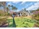 Beautiful backyard with a green lawn, trees and a screen porch at 644 Whispering Pines Ct., Murrells Inlet, SC 29576