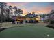 A private backyard with a putting green, patio, outdoor seating, and professional landscaping at 644 Whispering Pines Ct., Murrells Inlet, SC 29576