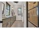 Bright bathroom features a double sink vanity, black framed windows and a glass enclosed shower at 644 Whispering Pines Ct., Murrells Inlet, SC 29576
