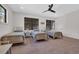 Neutral bedroom with three twin beds, carpet floors, black ceiling fan and two windows at 644 Whispering Pines Ct., Murrells Inlet, SC 29576