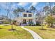 Charming two-story home with inviting front porch, manicured lawn, and beautiful landscaping at 644 Whispering Pines Ct., Murrells Inlet, SC 29576