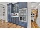 A modern kitchen features a large cabinet, stainless steel appliances, and a view into a well-stocked pantry at 644 Whispering Pines Ct., Murrells Inlet, SC 29576