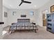 Spacious main bedroom features large windows, carpet floors, and a blue patterned bedspread at 644 Whispering Pines Ct., Murrells Inlet, SC 29576