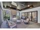 Inviting outdoor patio with a fireplace, ceiling fans, and cozy furniture, providing a perfect spot to unwind at 644 Whispering Pines Ct., Murrells Inlet, SC 29576