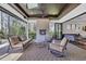 Covered outdoor patio features a fireplace, ceiling fan, skylight and comfortable seating overlooking the yard at 644 Whispering Pines Ct., Murrells Inlet, SC 29576