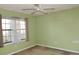 Bedroom featuring light green walls, a ceiling fan and a window at 6654 Wisteria Dr., Myrtle Beach, SC 29588