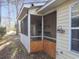Rear view of home featuring an enclosed porch and backyard at 6654 Wisteria Dr., Myrtle Beach, SC 29588