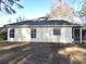 Exterior back view of home and enclosed porch with a level lot at 6654 Wisteria Dr., Myrtle Beach, SC 29588