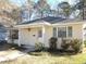 Cozy single-story home with a covered front porch, neatly trimmed shrubs, and a well-maintained yard at 6654 Wisteria Dr., Myrtle Beach, SC 29588
