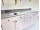 Outdoor kitchenette with granite counters, stainless sink, and paneled cabinets at 6654 Wisteria Dr., Myrtle Beach, SC 29588