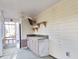 Enclosed porch with outdoor kitchenette, overhead fan, and entry to backyard at 6654 Wisteria Dr., Myrtle Beach, SC 29588