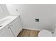 Bathroom vanity with white cabinets and a modern sink, paired with wood-look flooring at 7300 Porcher Dr. # 11, Myrtle Beach, SC 29572