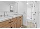 Bathroom featuring a double sink vanity, framed mirror and a tiled shower at 7300 Porcher Dr. # 11, Myrtle Beach, SC 29572