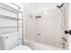 Bright bathroom featuring a shower-tub combo with modern fixtures and convenient storage shelves at 7300 Porcher Dr. # 11, Myrtle Beach, SC 29572