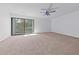 Spacious bedroom featuring carpeted floors, a ceiling fan, and a sliding glass door leading to a balcony at 7300 Porcher Dr. # 11, Myrtle Beach, SC 29572