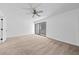 Bright bedroom featuring carpeted floors, a ceiling fan, and a sliding glass door leading to a balcony at 7300 Porcher Dr. # 11, Myrtle Beach, SC 29572