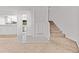 Welcoming entryway with tile and carpet, leading to kitchen and stairs at 7300 Porcher Dr. # 11, Myrtle Beach, SC 29572