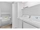 Laundry room with a washer and dryer next to stairway at 7300 Porcher Dr. # 11, Myrtle Beach, SC 29572