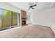 Open-plan living room with brick fireplace and sliding glass doors to the outside at 7300 Porcher Dr. # 11, Myrtle Beach, SC 29572