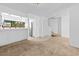View of the living room leading to the kitchen with bright white walls and neutral flooring at 7300 Porcher Dr. # 11, Myrtle Beach, SC 29572