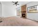 Living room showing brick fireplace, neutral carpet, and access to outdoor area at 7300 Porcher Dr. # 11, Myrtle Beach, SC 29572