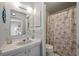 Well-lit bathroom featuring a vanity, mirror, and a shower with a themed curtain at 800 9Th Ave. S # T3, North Myrtle Beach, SC 29582