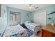 Guest bedroom features two twin beds, ceiling fan, and a view from the window at 800 9Th Ave. S # T3, North Myrtle Beach, SC 29582