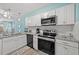 Modern kitchen featuring white cabinets, stainless steel appliances, and granite countertops at 800 9Th Ave. S # T3, North Myrtle Beach, SC 29582
