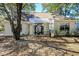 Backyard with a screened-in porch area, perfect for outdoor dining and relaxation with mature trees at 81 Safe Harbor Ave., Pawleys Island, SC 29585