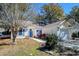 Well-maintained home with blue shutters and a tidy front yard featuring landscaping and a paved walkway at 81 Safe Harbor Ave., Pawleys Island, SC 29585