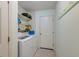 Functional laundry room featuring a washer, dryer, and shelving for storage at 81 Safe Harbor Ave., Pawleys Island, SC 29585